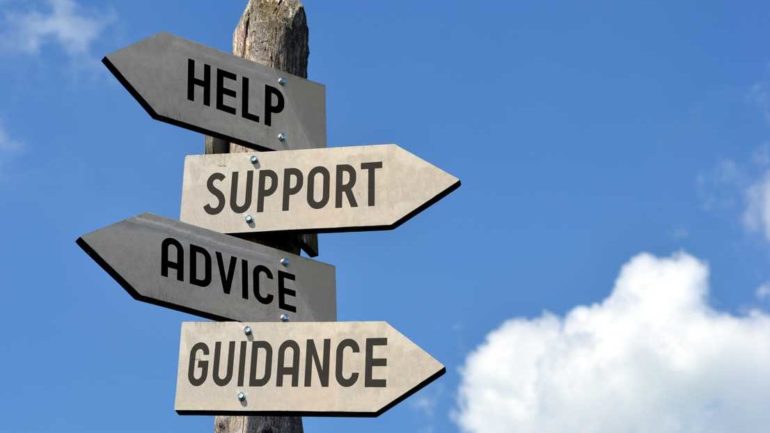 Old-fashioned Wooden sign backed by blue skies says help, advice, guidance, support.